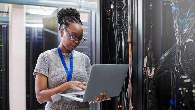 A person using lap in server room