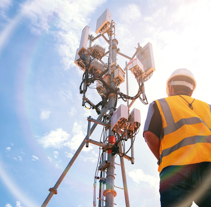 A person observing a network communications pole