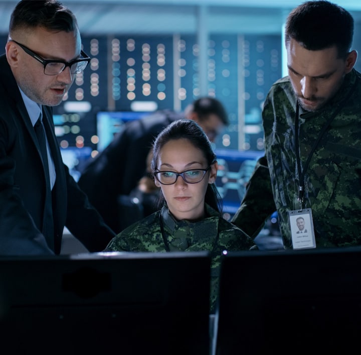 Three People looking at a computer