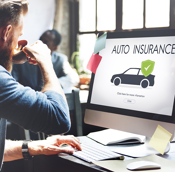 A person on a laptop looking at auto insurance website