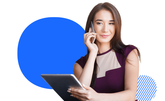 A person holding a tablet, talking on a mobile phone
