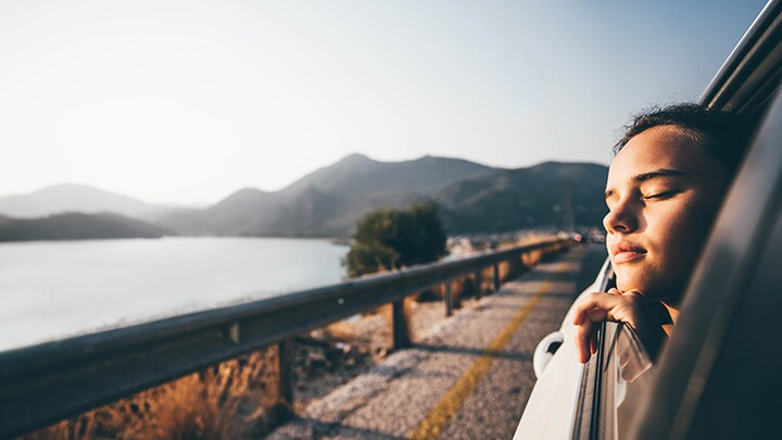 Girl looking out window of car