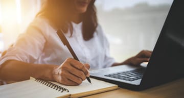 A woman studying on laptop