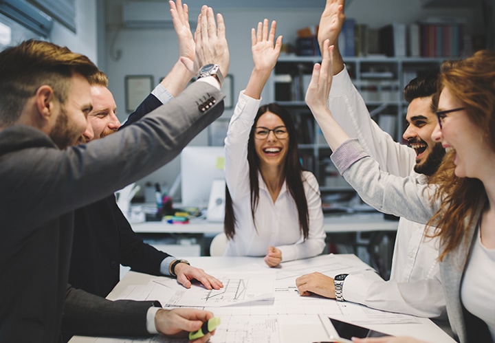 Coworkers doing a group high five