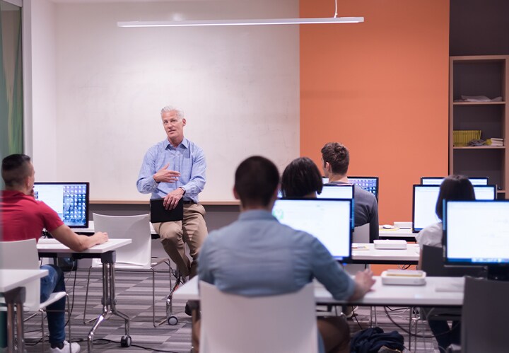 A person giving a lecture to a group of people